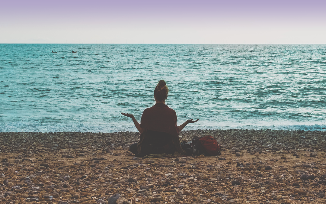 woman meditating on beach for blog about finding relief from COPD with salt therapy